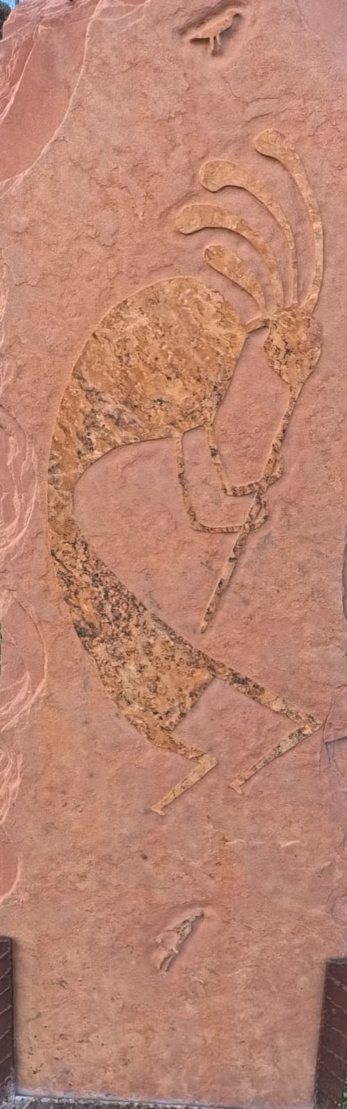 Hand-carved sandstone relief of Kokopelli, the Native American flute player